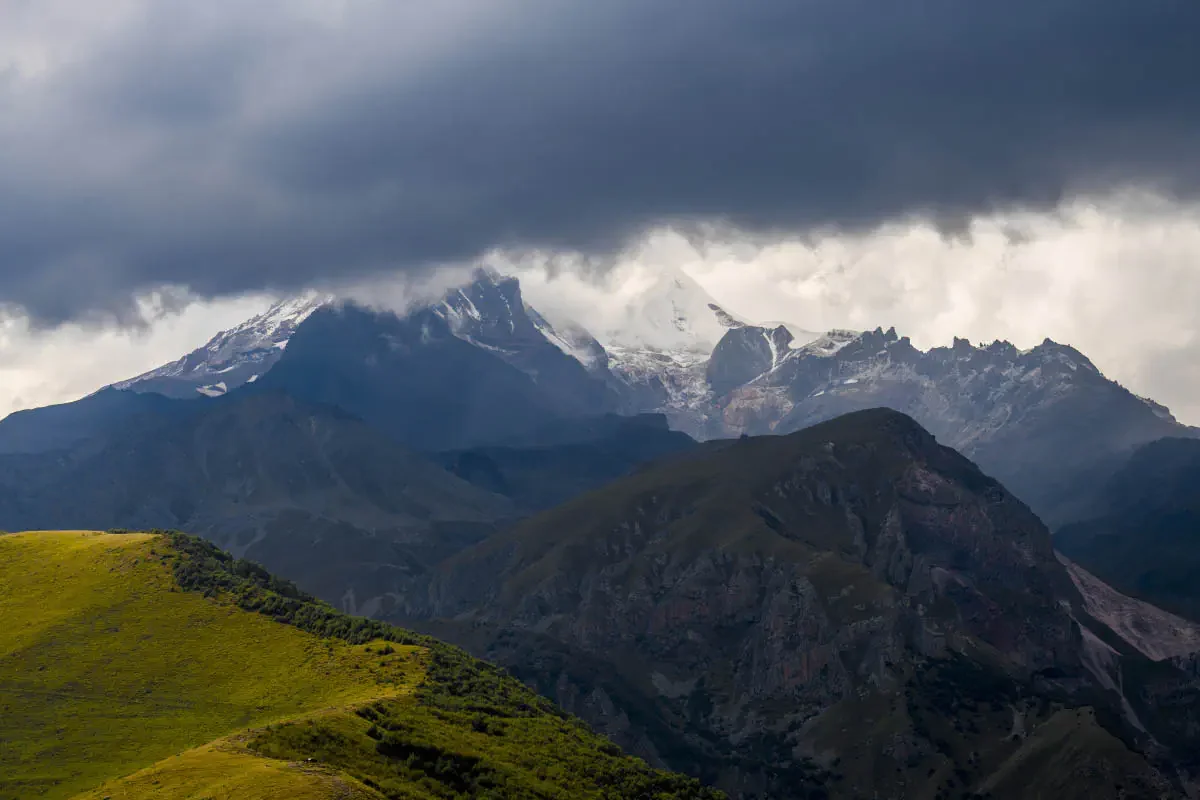 Mount Kazbek (5033.8 m) in the clouds. Northeast Georgia